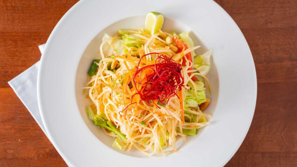Som Tum (Papaya Salad) · This classic salad is popular throughout Thailand for centuries. Shredded green papaya, carrot, tomatoes tossed with tangy and dressing topped with ground peanuts.