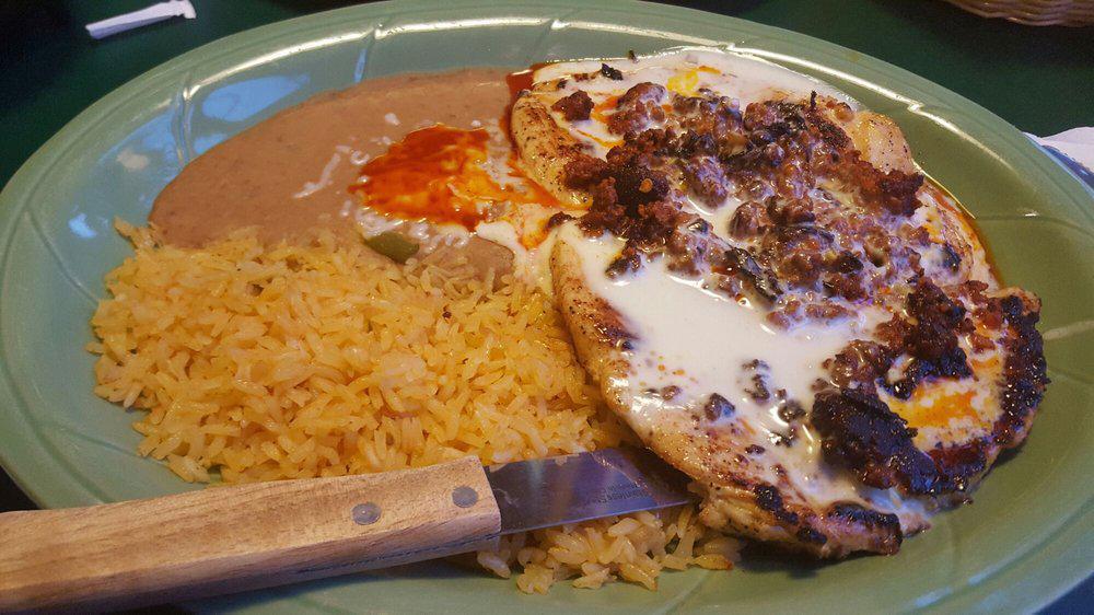 Chori Pollo · Thin sliced chicken breast grilled and topped with Mexican chorizo, onions and cheese dip. Served with Mexican rice and refried beans.