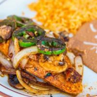 Pollo Borracho · Thin sliced chicken breast topped with sautéed jalapeño, onions and mushrooms glazed in whit...