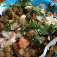 Papri Chaat · Indian Wafer topped with Chickpeas, Onions, & Tomatoes with Tamarind, Cilantro, & Yogurt Chu...