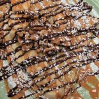 Funky Monkey · Scratch made crepe drizzled with Nutella and peanut butter & topped with walnuts and powdere...