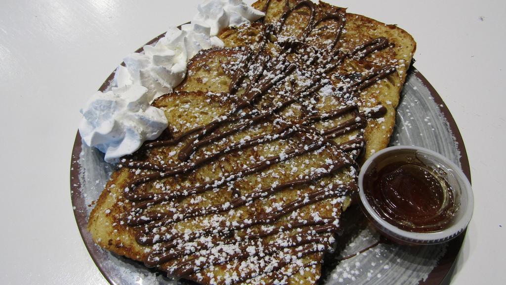 Nutella French Toast · 4 big slices of thick, house made French toast drizzled with Nutella and finished with powdered sugar.