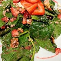 Strawberry Walnut Salad · Fresh spinach & strawberries tossed in our house made strawberry vinaigrette topped with wal...