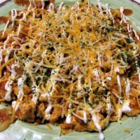 Spicy Chorizo Scramble · 6 scrambled eggs cooked with chorizo and topped with house made enchilada sauce and sour cre...