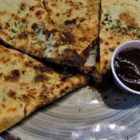 The Bbquesadilla · Smoked pulled chicken, cheddar jack cheese, diced onions and BBQ sauce melted together insid...
