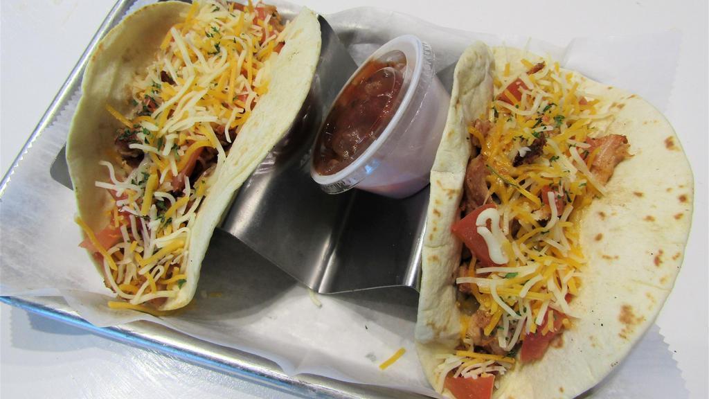 Chicken Tacos · Smoked pulled chicken topped with diced tomatoes and cheddar jack cheese served in your choice of flour or corn tortillas.