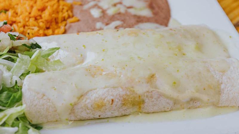 Burritos Tapatios · 2 grilled chicken or steak burritos topped with cheese dip. Served with beans, rice, lettuce, pico de gallo, and sour cream.
