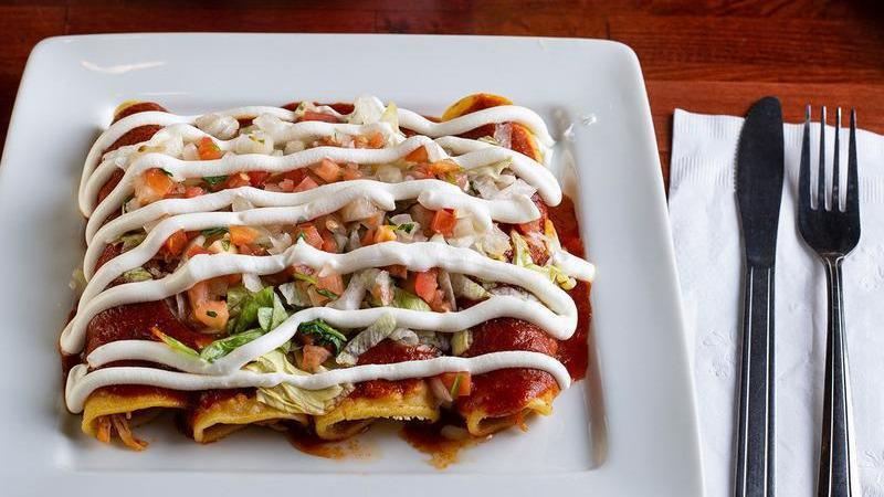 Enchiladas Supreme · A bean, cheese, beet, and chicken enchiladas topped with lettuce, pico de gallo, and sour cream.