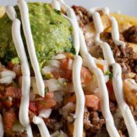 Nachos Fries · Fries topped with steak, cheese, pico de gallo, guacamole, and sour cream.