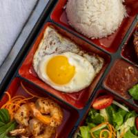 Com Dac Biet · Rice bento box served w/ grilled 5-spice marinated pork loin, shrimps, sunny-side-up organic...