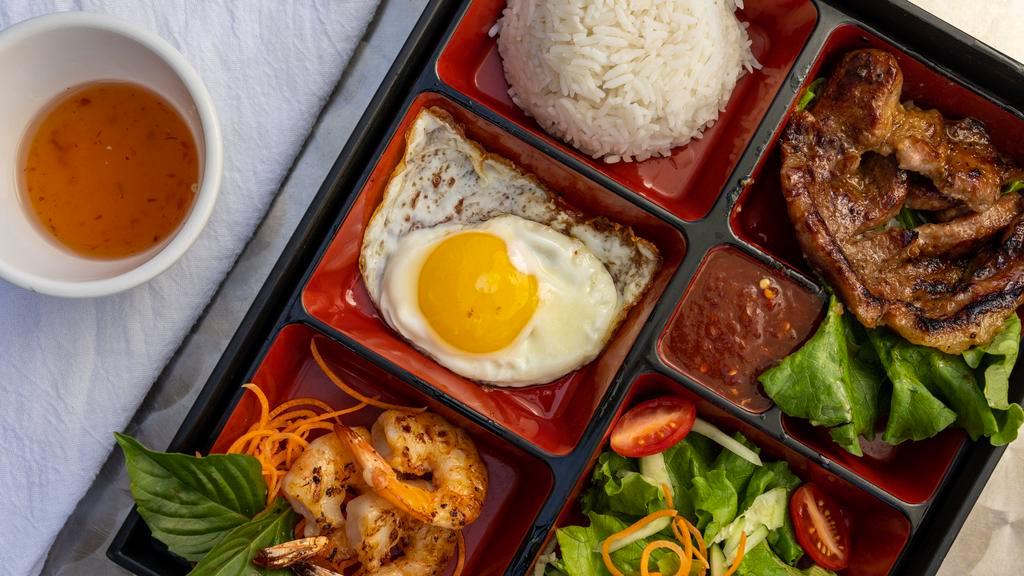 Com Dac Biet · Rice bento box served w/ grilled 5-spice marinated pork loin, shrimps, sunny-side-up organic egg*, lettuce, tomatoes, cucumber salad and eatz's special blended fish sauce.