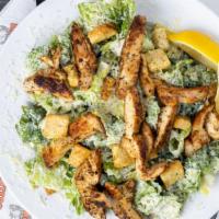 Chicken Caesar Salad · Fresh chopped romaine, Parmesan cheese, and crispy seasoned croutons with a creamy Caesar dr...