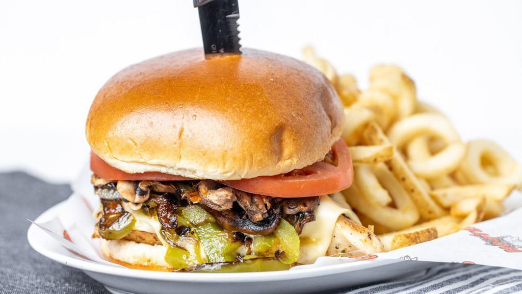Smothered Chicken Sandwich · Plump, juicy, grilled chicken breast smothered in melted provolone cheese, sauteed onions, green peppers, and mushrooms, and served on a toasted brioche bun. It's big and a little messy. Like family. Served with a side.