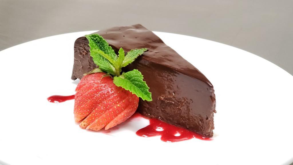 Chocolate Sin Cake · Rich flourless cake, ganache, raspberry sauce | gf