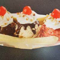 Banana Split · Chocolate, vanilla and strawberry ice cream topped with hot fudge, whipped cream, chopped nu...