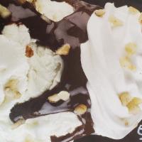 Brownie Sundae · Vanilla ice cream on a brownie topped with hot fudge, whipped cream, chopped nuts and a cher...