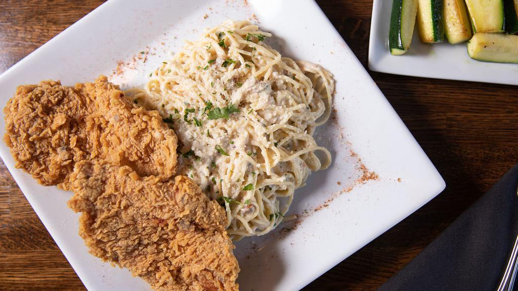 Bc Chicken Alfredo · Two pieces of crispy fried chicken breasts served on thin spaghetti in alfredo sauce. A side of your choice is included.