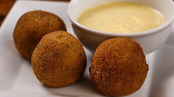 Cheese Balls (6) · 6 pieces of fried cheese balls with mozzarella, cheddar cheese, bacon, and broccoli.  Served with our delicious honey mustard dressing.