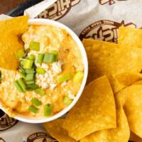 Buffalo Chicken Dip · A homemade creamy blend of cheeses, slow-cooked shredded chicken and buffalo sauce topped wi...