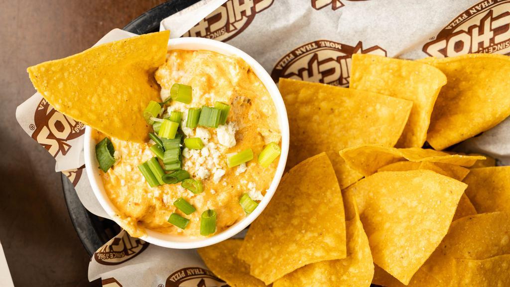 Buffalo Chicken Dip · A homemade creamy blend of cheeses, slow-cooked shredded chicken and buffalo sauce topped with bleu cheese crumbles and scallions served with tortilla chips.