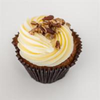 Carrot Cake · A carrot cake with pecans and coconut flakes, topped with a cream cheese icing