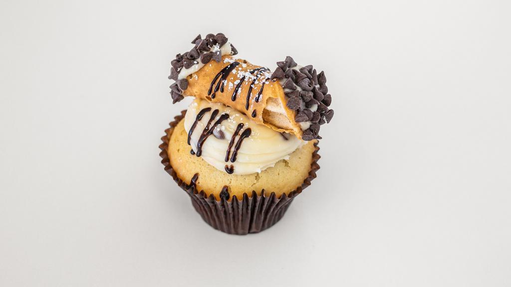 Holy Cannoli · A vanilla cake with chocolate chips, topped with a chocolate chip creamcheese icing and  cannoli