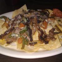 Nachos Mexicanos · Cheese nachos made with your choice of fajita meat (chicken, beef or mix).