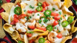 Shrimp Nachos · Cheese nachos topped with grilled shrimp and cooked with onions and bell peppers.
