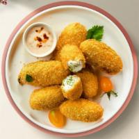 Fiery Jalapeño Poppers · Fried jalapeños filled with gooey melty cheese, served with ranch.