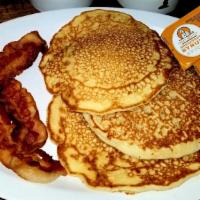 Pancakes W/ Bacon · 3 buttermilk pancakes w/ 2 strips of bacon w/ butter & syrup then topped with powdered sugar.