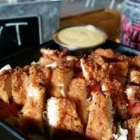 Chicken Tender Salad · Hand cut chicken (grilled or fried), cheddar, tomatoes, red onions, and choice of dressing.