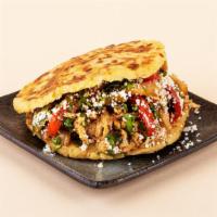 Fajita Arepa · Your choice of protein with shredded cheese, sauteed peppers and onions, and cilantro betwee...