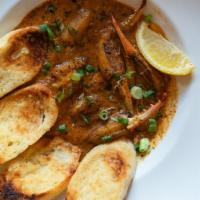 Blue Crab Claws · Fresh blue crab claws sautée in a lemon, garlic butter sauce with toasted French bread for d...