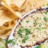 Spinach & Artichoke Dip · Creole creamy spinach dip served with tortilla chips topped with Parmesan cheese and red pep...
