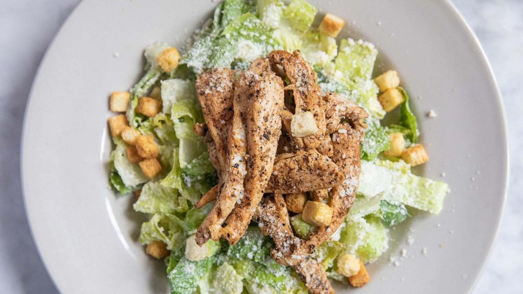 Chicken Caesar Salad · Grilled or blackened chicken breast, fresh romaine lettuce tossed with a creamy Caesar dressing, croutons, Parmesan cheese