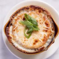 French Onion Soup · Classic beef stock with caramelized onions, house made croutons, topped with Parmesan and mo...