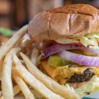Royal House Cheeseburger · Angus beef patty topped with Cheddar cheese, lettuce, tomato, red onions, and pickles on a t...