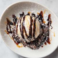 Brownie A La Mode · Homemade nut brownie iced with a chocolate ganache. Topped with a scoop of vanilla bean ice ...