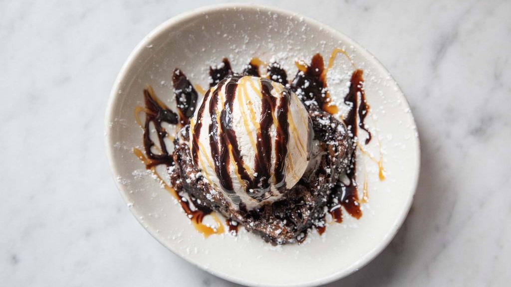 Brownie A La Mode · Homemade nut brownie iced with a chocolate ganache. Topped with a scoop of vanilla bean ice cream,  whipped cream, and chocolate sauce.