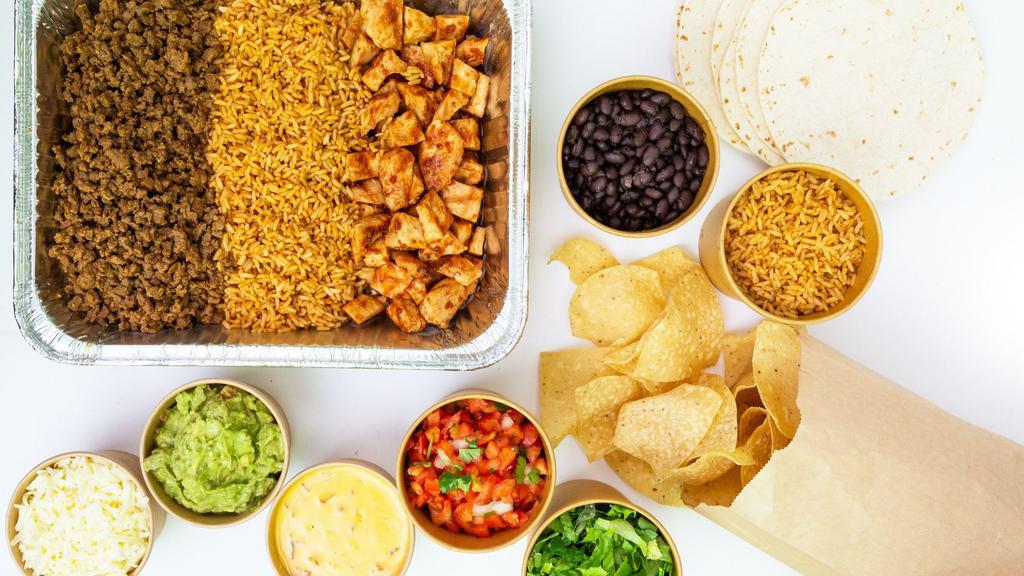 Family Taco Night · A taco meal for 4-6 members that includes your choice of grilled mesquite chicken or grilled mesquite chicken and taco beef as well as rice, black beans, 10 soft flour tortillas, lettuce, Jack cheese, sour cream, salsa, guac, queso and tortilla chips.