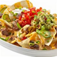 Nachos · White corn tortilla chips topped with queso, jalapeños, sour cream, guacamole, scallions and...