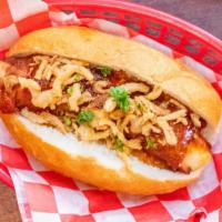 The King Brat Sandwich · Smoked pork sausage filled with white cheddar, wrapped in applewood-smoked bacon & topped wi...