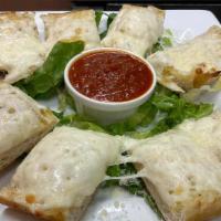 Garlic Cheese Bread · Italian bread with butter and garlic topped with melted mozzarella cheese.