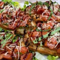 Tomato Bruschetta · Toasted bread topped with seasoning, fresh tomato, basil, garlic, olive oil, and onion. Topp...