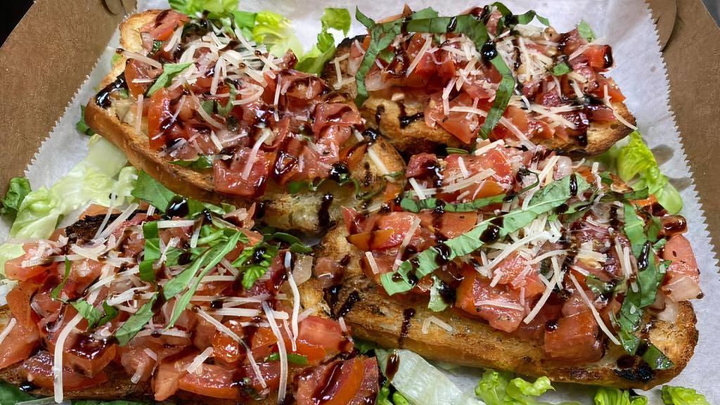 Tomato Bruschetta · Toasted bread topped with seasoning, fresh tomato, basil, garlic, olive oil, and onion. Topped with balsamic glaze.