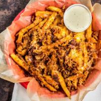 Bacon Cheese Fries · Waffle fries smothered in Cheddar and Jack cheeses, topped with chopped bacon, then coated w...