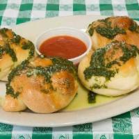 Garlic Knots · Four pieces with sauce.