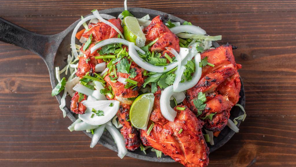 Charred Tandoori Chicken · Chicken pieces marinated in yogurt and powdered spices, grilled in a clay pot tandoor till the outside is beautifully charred and the meat is juicy, succulent and falls of the bone