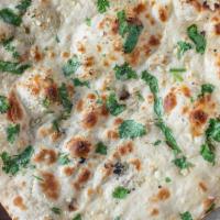 Naan · House made pulled and leavened dough baked to perfection in an Indian clay oven