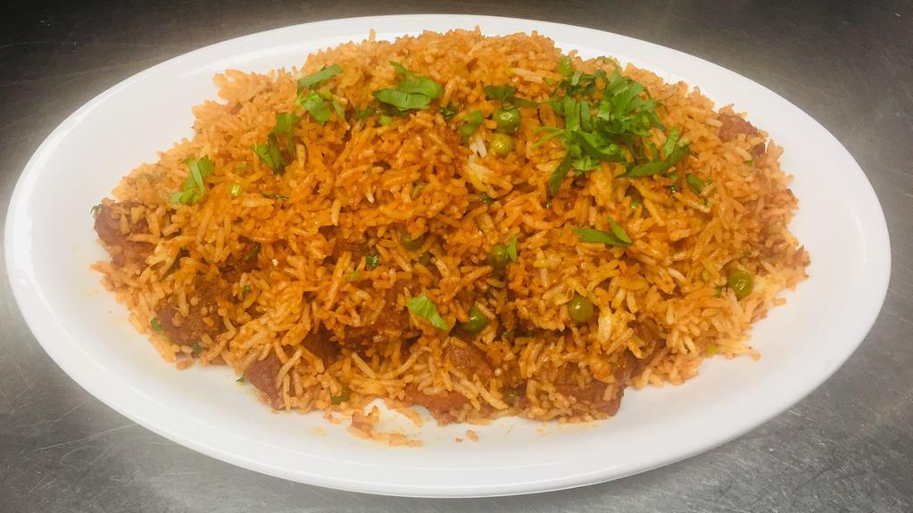 Lamb Biryani · Basmati rice with lamb in a masterful blend of spices. Garnished with nuts and raisins.